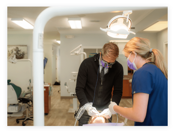 Image of Dr. Henry and an orthodontic assistant completing an orthodontic procedure