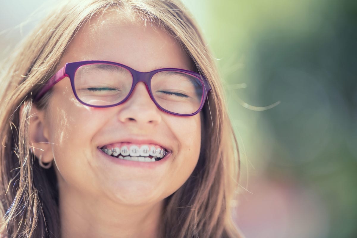 child smiling with her braces