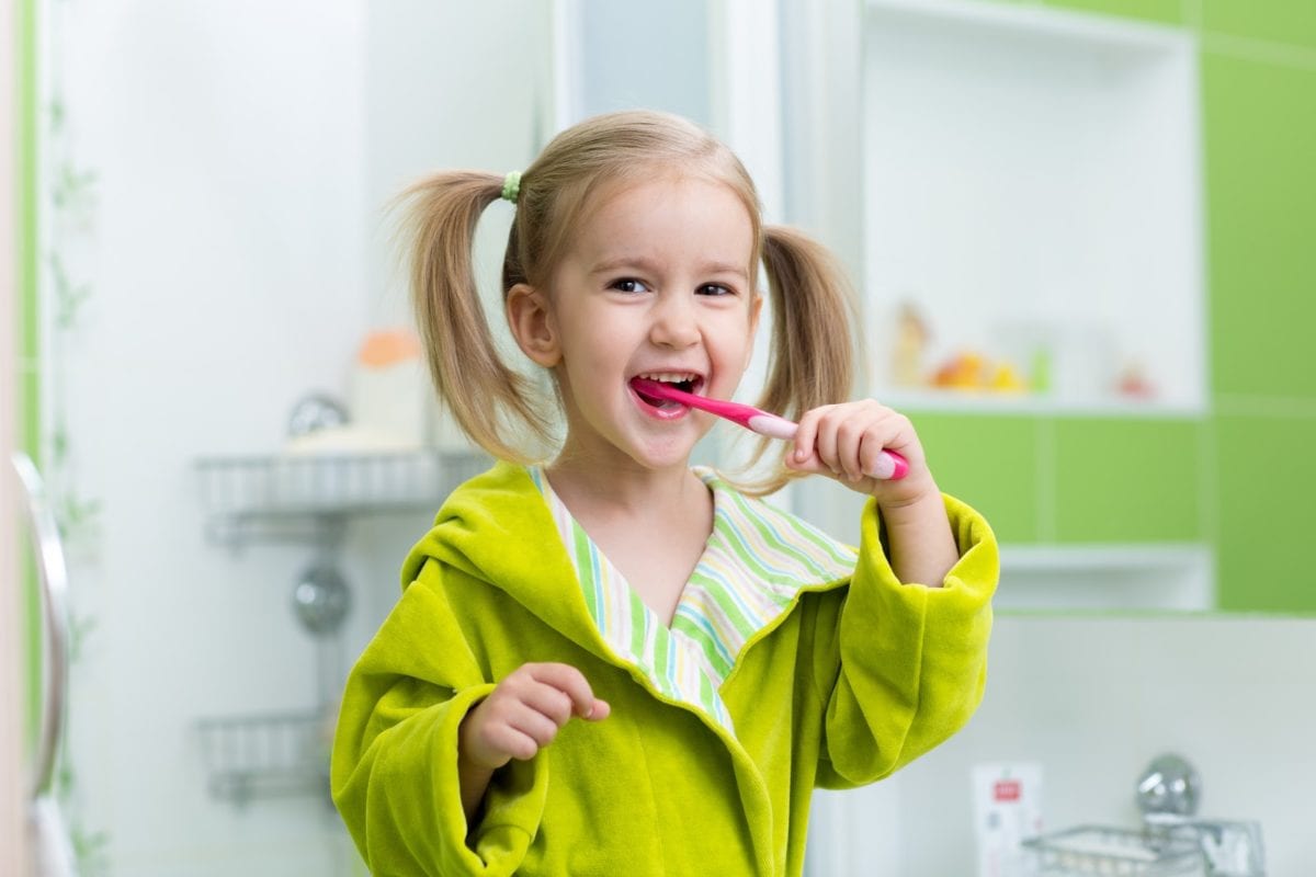 Photo of child brushing teeth and illustrating good dental care for kids